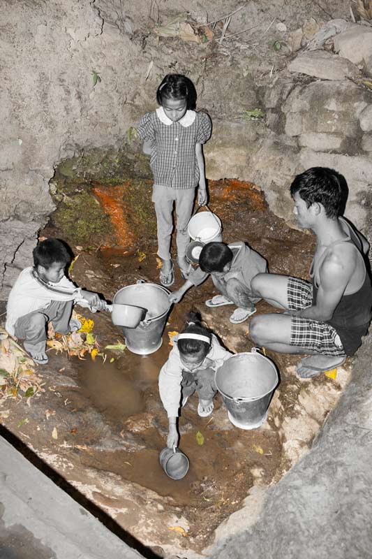 Human Right to Water in Nagaland - Children taking water in the evening from a visibly unclean spring-fed drinking water source